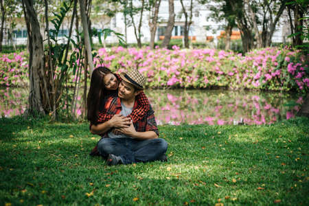 Romantic Young Couple Sitting In Gardenの写真素材