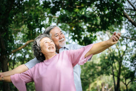 Happy senior couple in the parkの写真素材