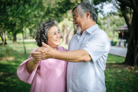 Happy senior couple in the parkの写真素材