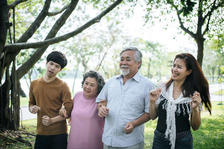 happy  family walking outdoor in the parkの写真素材