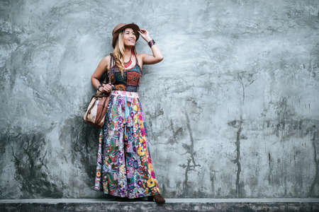 Happy woman positive and beautiful blonde pousing over white wallの写真素材
