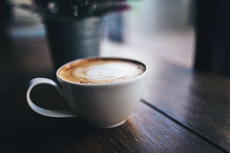 Coffee cup on table in cafeの写真素材