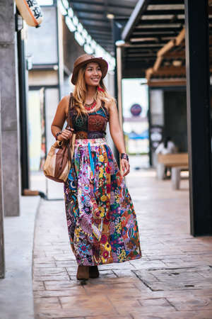 The woman is walking on the street with great smile.の写真素材