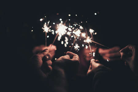 Group of happy people holding sparklers at party and smiling.の写真素材