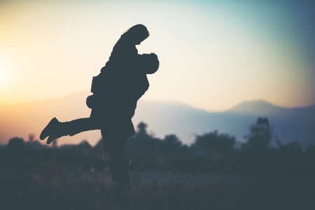 silhouette of Couple in love silhouette during sunsetの写真素材