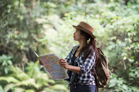 young women people Hiking with friends backpacks walking together and looking map and taking photo camera by the road and looking happy ,Relax time on holiday concept travelの写真素材