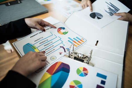 Close up of business people working with business document during discussion at meeting.の写真素材