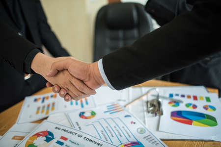 businessman shaking hands to seal a deal with his partnerの写真素材