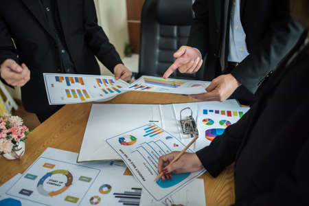 Close up of business people working with business document during discussion at meeting.の写真素材