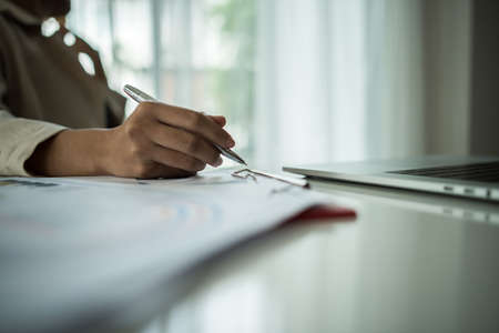 Close up of business people working with business document during discussion at meeting.の写真素材