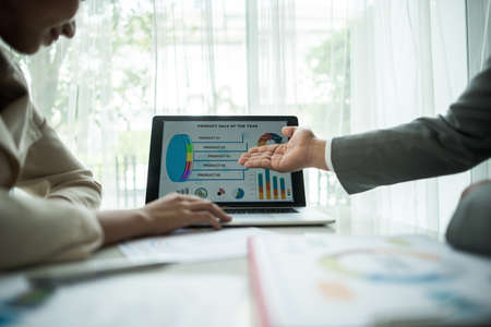 Close up of business people working with business document during discussion at meeting.の写真素材