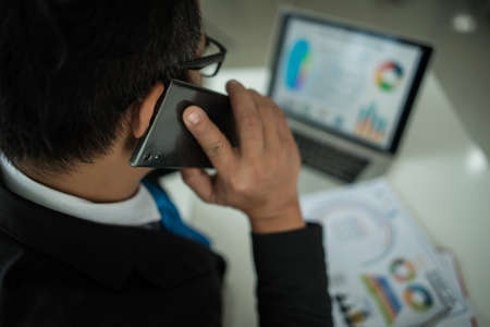 Young businessman working with laptop at officeの写真素材