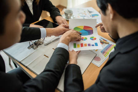 Close up of business people working with business document during discussion at meeting.の写真素材