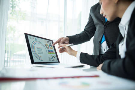 Close up of business people working with business document during discussion at meeting.の写真素材