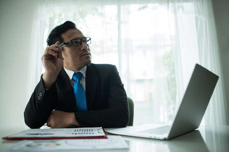 Young businessman working with laptop at officeの写真素材