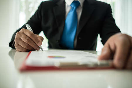 Young businessman working with laptop at officeの写真素材