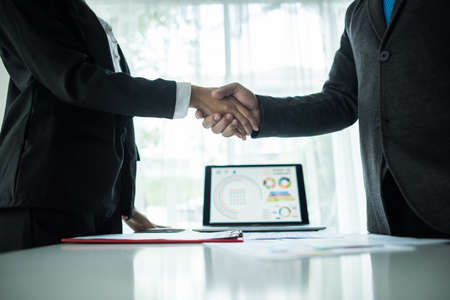 businessman shaking hands to seal a deal with his partnerの写真素材