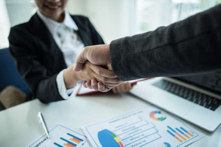 businessman shaking hands to seal a deal with his partnerの写真素材