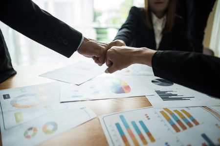 Close up of business people working with business document during discussion at meeting.の写真素材