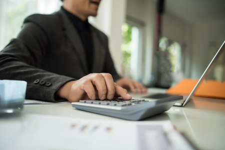 Close up of business people working with business document during discussion at meeting.の写真素材