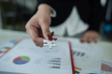 business documents over papers with numbers and charts. View from above