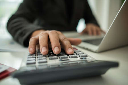 Close up of business people working with business document during discussion at meeting.の写真素材