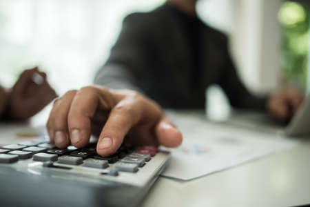 Close up of business people working with business document during discussion at meeting.の写真素材