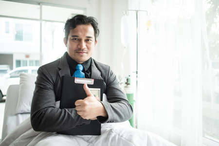 Business man with suit working with oxygen mask in the office. Sick man work in the office alone