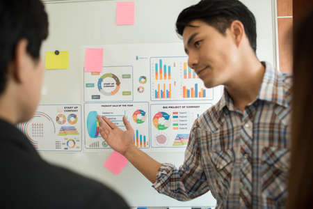 Close up of business people working with business document during discussion at meeting.の写真素材