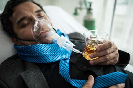 Businessman Working on Hospital Bed with Saline Solution On Patients Handの写真素材