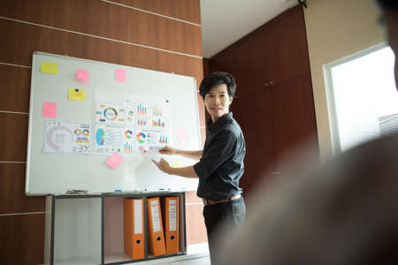 Close up of business people working with business document during discussion at meeting.の写真素材