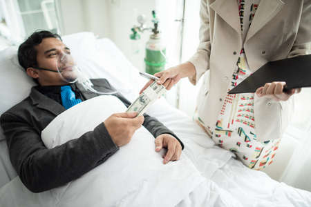 Business man with suit working with oxygen mask in the office. Sick man work in the office aloneの写真素材