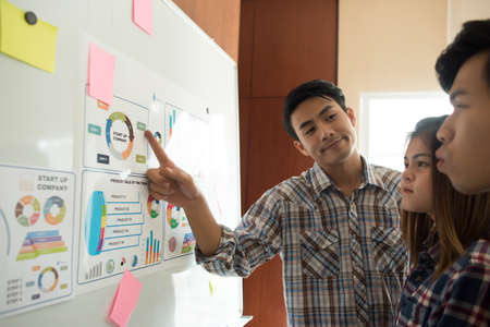 Close up of business people working with business document during discussion at meeting.の写真素材