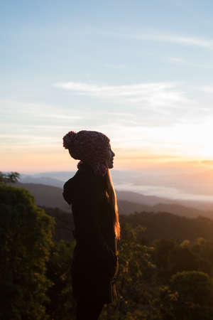 hiking woman enjoy the beautiful view at mountain peakの写真素材