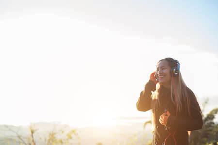 woman is listening to music on Mountainの写真素材