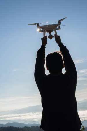 Men's hands hold the drone, pick it upの写真素材