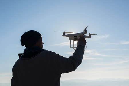 Men's hands hold the drone, pick it upの写真素材