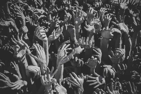 Hand from hell - Buddhist architecture in front of Buddhist white templeの写真素材