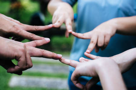 Women and men friends make star shape from fingers. Success, friendship concept.の写真素材