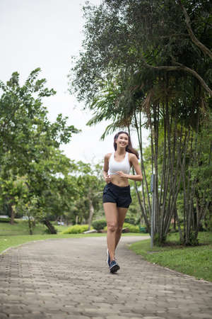 Young beautiful sport woman running at the park. Health and sport concept.の写真素材