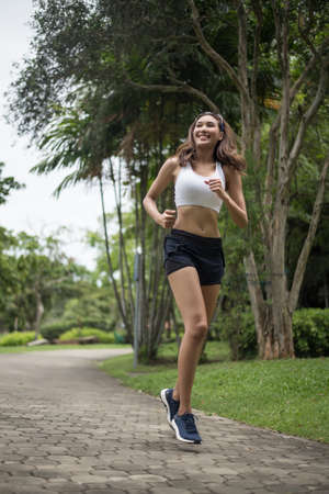 Young beautiful sport woman running at the park. Health and sport concept.の写真素材