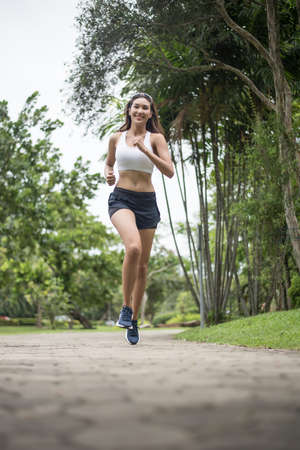 Young beautiful sport woman running at the park. Health and sport concept.の写真素材