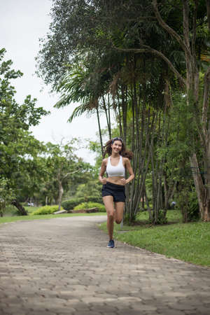 Young beautiful sport woman running at the park. Health and sport concept.の写真素材