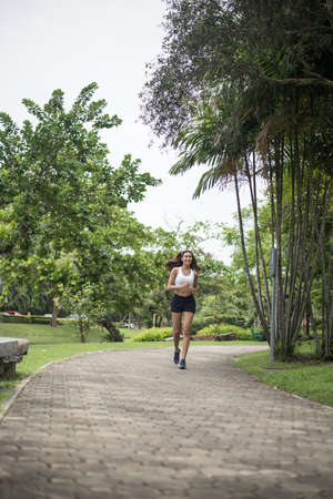 Young beautiful sport woman running at the park. Health and sport concept.の写真素材