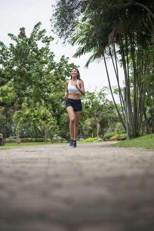 Young beautiful sport woman running at the park. Health and sport concept.の写真素材