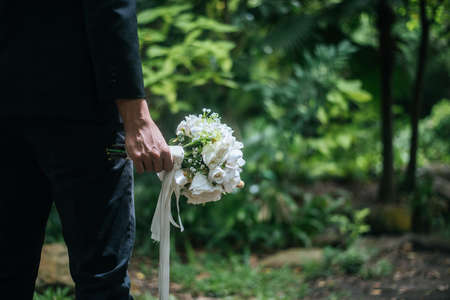 Beautiful bouquet in the hands of the groom for bride.の写真素材