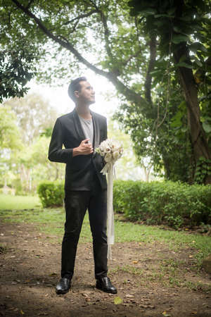 Beautiful bouquet in the hands of the groom for bride.の写真素材