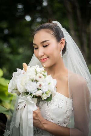 Close up of Beautiful Bride with wedding bridal bouquet.