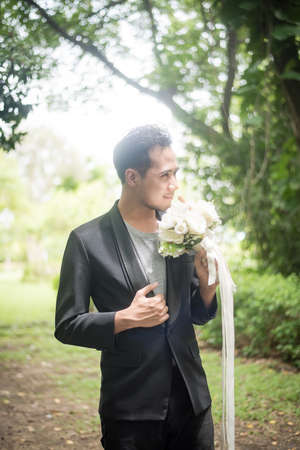 Beautiful bouquet in the hands of the groom for bride.の写真素材