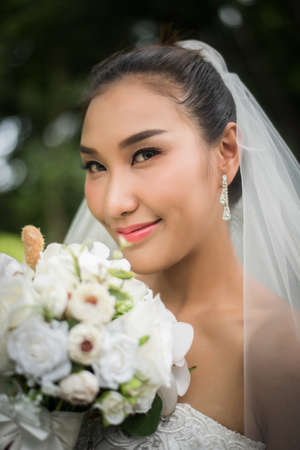 Close up of Beautiful Bride with wedding bridal bouquet.の写真素材